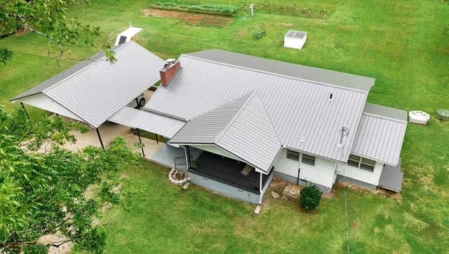 Aerial view of a silver metal roof on a farmhouse