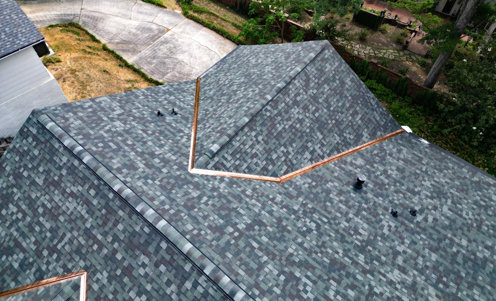 Close-up of copper valley flashing on an architectural shingle roof